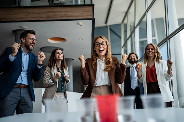 istock Business team cheering playing office beer pong game 2241176926