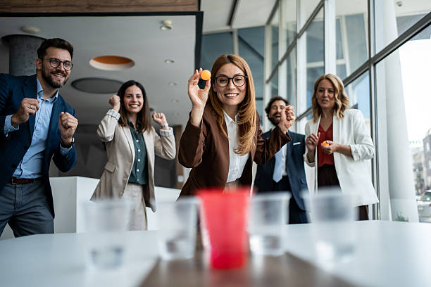 istock Businesspeople playing beer pong, team building activity 2241176931