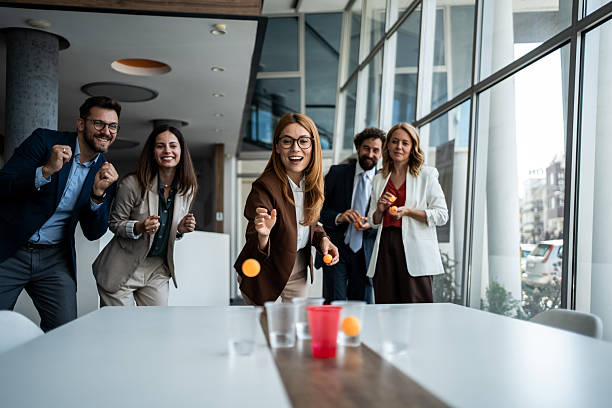 istock Business colleagues having fun playing beer pong in office 2241176962