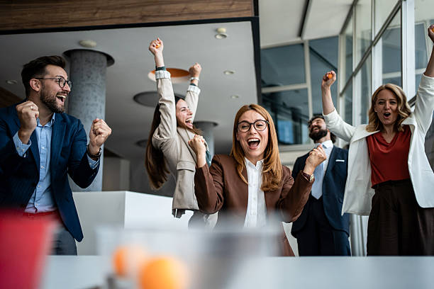 istock Business team cheering celebrating success in modern office 2241176969