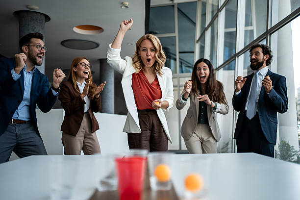 istock Business team celebrating victory playing beer pong 2241176973