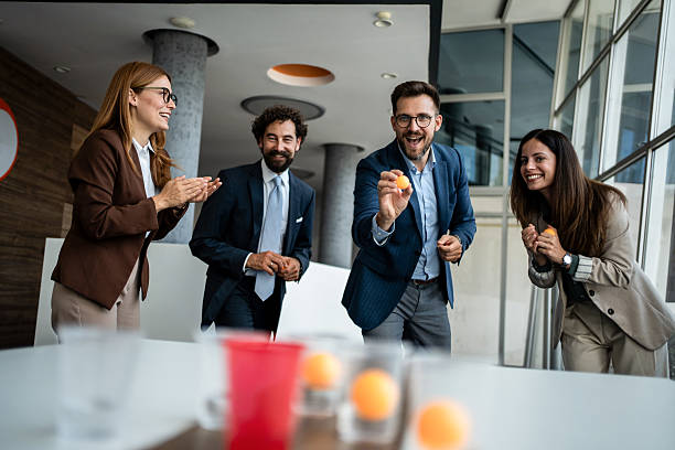 istock Colleagues playing table tennis game during office break 2241177007