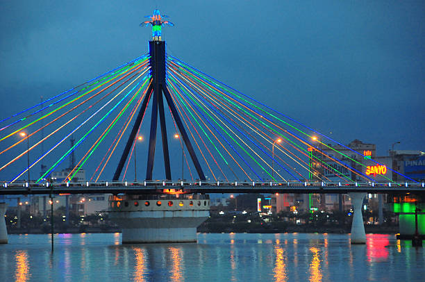 Da Nang, Vietnam: the Han River Bridge, known locally as Cầu Sông Hàn, spans the Han River , serving as a vital connection between the eastern and western parts of the city. Completed in 2000, this 488-meter-long and 13-meter-wide structure features 11 spans and is distinguished as Vietnam's first and only operational swing bridge, designed and built by Vietnamese engineers. Its central section rotates 90 degrees to permit large vessels to pass.