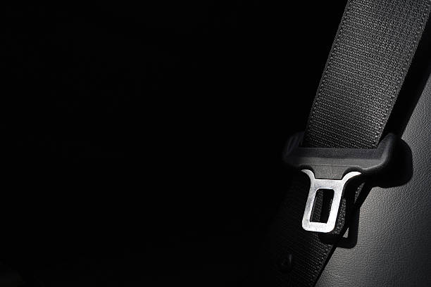 Close-up of traveler buckling seatbelt on a flight, highlighting airline safety