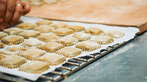 istock Homemade pasta squares prepared on a baking sheet sprinkled with flour ready for cooking a delicious Italian meal 2241183298