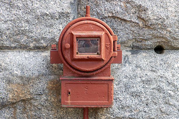 Old fire alarm on outdoor wall