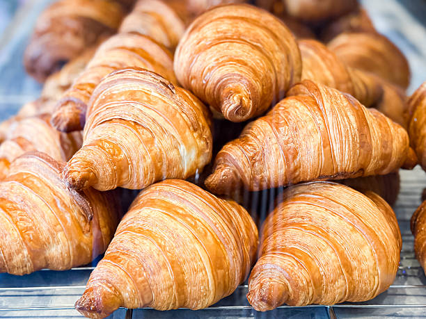 istock Golden Croissants on Cooling Rack in Bakery Display 2241185589