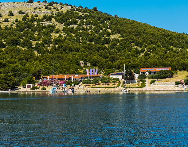 Scenic Waterfront Resort with Green Hills and Boats