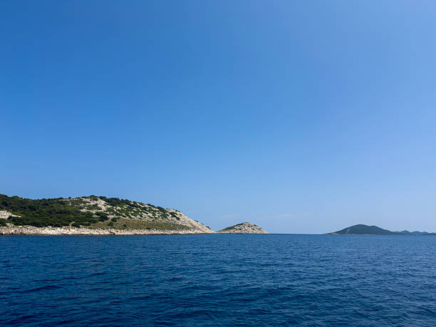 Tranquil Seascape with Rocky Islands and Azure Sky