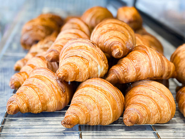 istock Golden Croissants on Cooling Rack in Bakery Display 2241186129