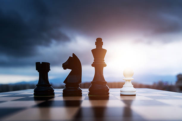 istock White chess pawn and black pieces on chess board 2241188638