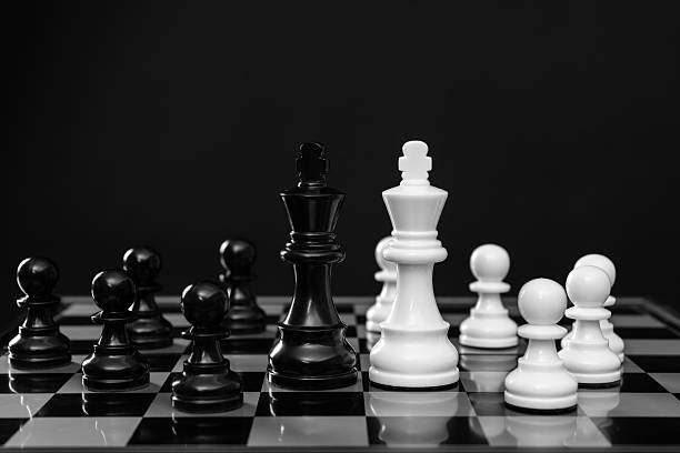 Close up king chess challenge or battle fighting with falling chess on chess board concepts of leadership and strategy or strategic plan and human resource or risk management or team player.