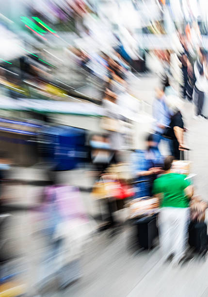 Crowd of people walking indoors walkway, blurred totion