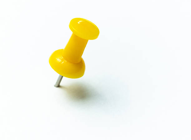 istock Yellow thumbtack with shadow on white background 2241189699