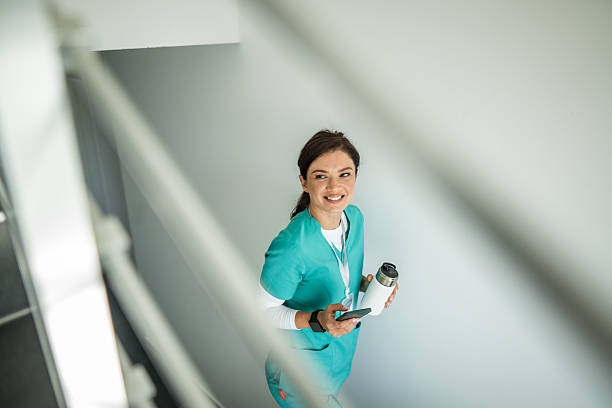 istock Nurse smiling taking break on hospital stairs 2241190019