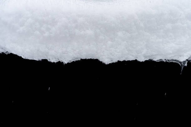 istock Natural snow isolated on black background 2241192734