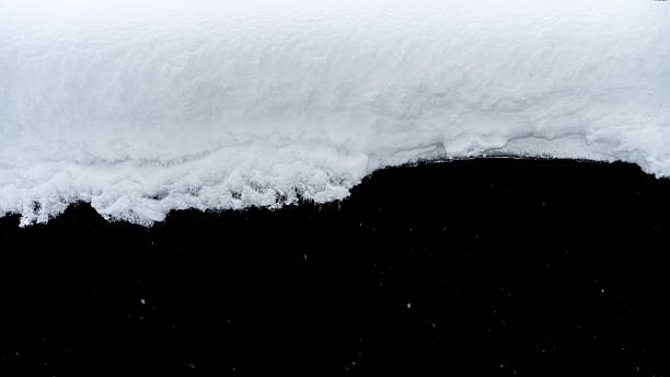 istock Natural snow isolated on black background 2241192780