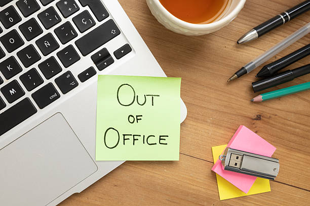 istock Green Sticky Note with Out of Office Message on Desk 2241193050