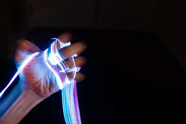 istock Hands Glowing in the Dark with Neon Wires 2241199744