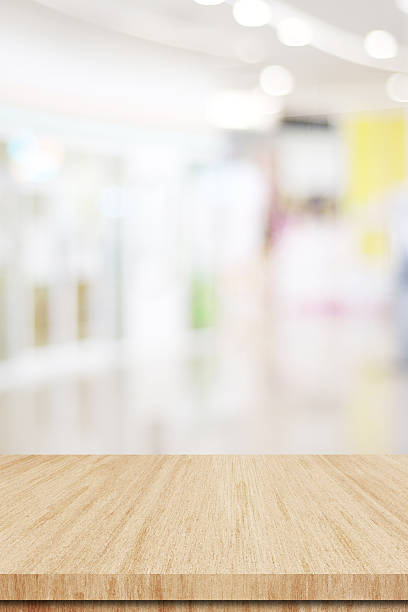 Table and blur background, Wooden counter over blur bokeh light background, Brown wood table top, shelf for food and retail shop, store product display backdrop, banner, mockup, template , vertical