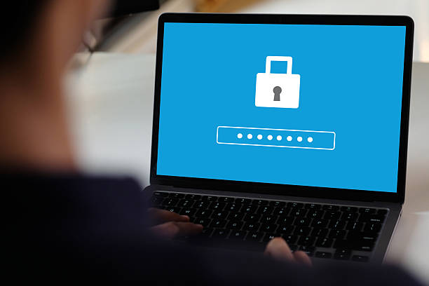istock Hand tying laptop computer with password login on screen, cyber security concept 2241201890