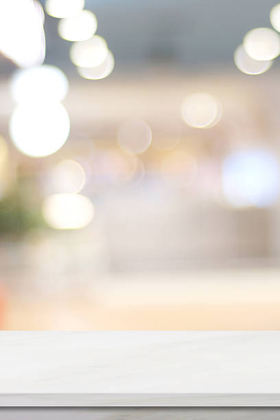istock Empty vertical white table top, counter, desk background over blur  bokeh background, White marble stone table, shelf and blurred kitchen restaurant for food, product display mockup, template 2241201944