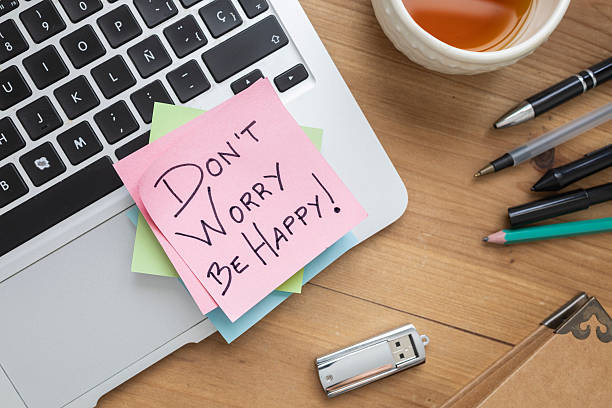 istock Don't Worry be Happy Sticky Note on Laptop 2241202024