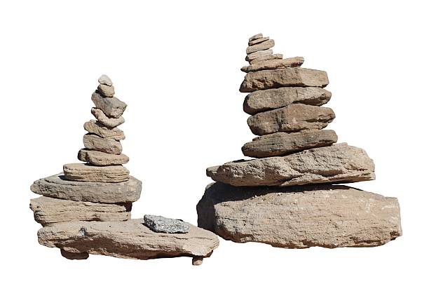 Two cairns of stone rocks on a white background representing stability and tranquility