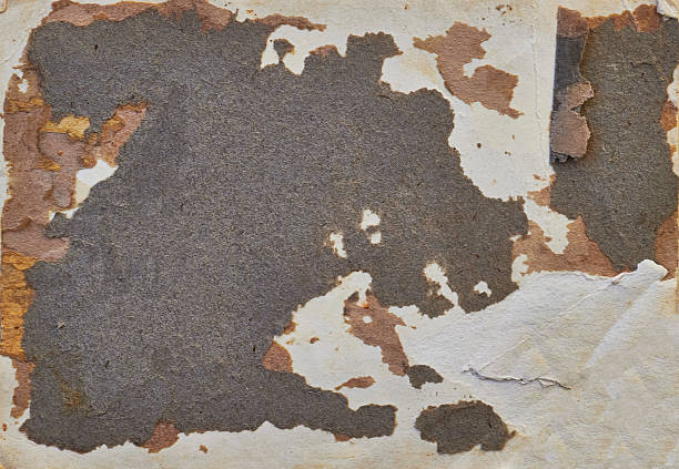 A rugged, weathered paper card featuring heavy peeling layers and rusty tones