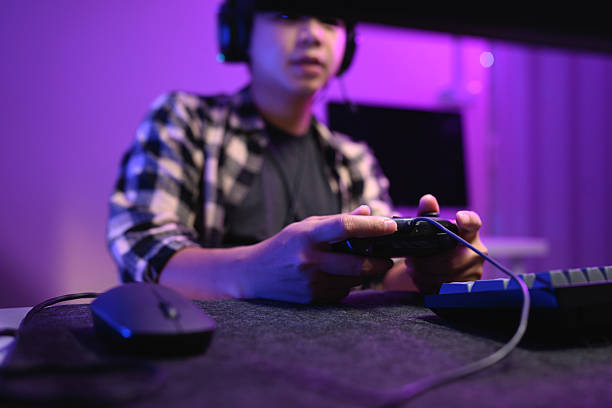 istock Closeup man playing video game at night with headset and neon RGB lighting 2241210209
