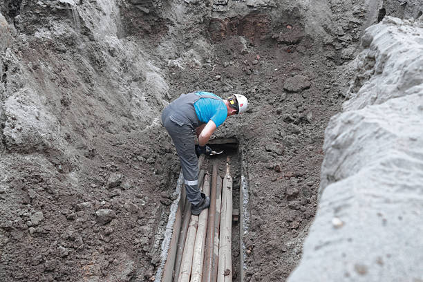 istock Male worker inspecting underground pipes in construction site 2241211452