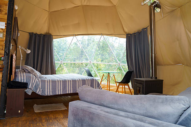 istock Glamping dome interior with bed and wood stove 2241212099