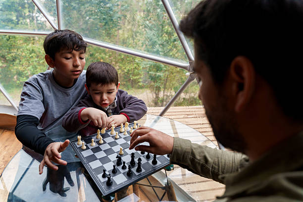 istock Family playing chess in glamping geodesic dome in chile 2241213106