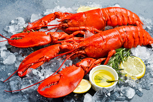istock Steamed red lobsters with lemon, ready to eat. Side view. Close-up. 2241214409