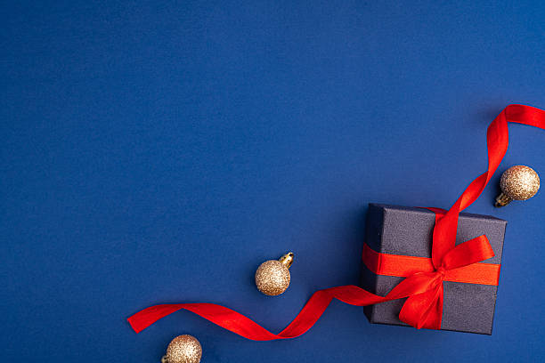 istock Christmas Gift Box with Red Ribbon and Festive Decorations 2241214460