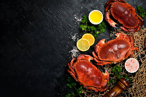 istock Delicious boiled large crabs with claws, served with lemon, salt and spices. A great appetizer with beer or wine. 2241215021