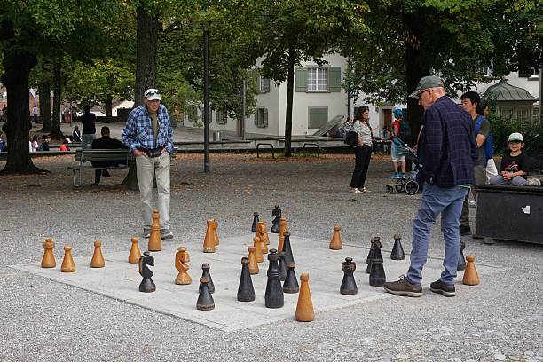 Zurich, Switzerland - 13 September 2025: A game of chess is underway on Lindenhof Hill, near Zurich city centre, using giant chess pieces.