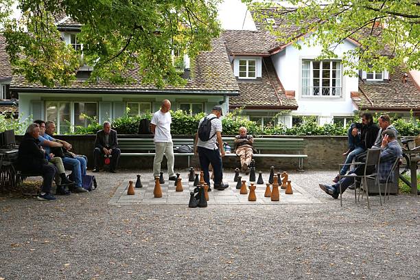 Zurich, Switzerland - 13 September 2025: A game of chess is underway on Lindenhof Hill, near Zurich city centre, using giant chess pieces.