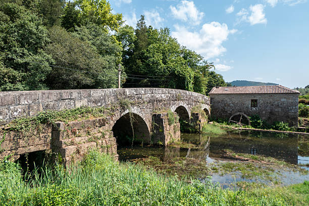 Views of the old watermill or water mill, with its wheel and the medieval bridge over the Estorãos River in Ponte de Lima, Portugal