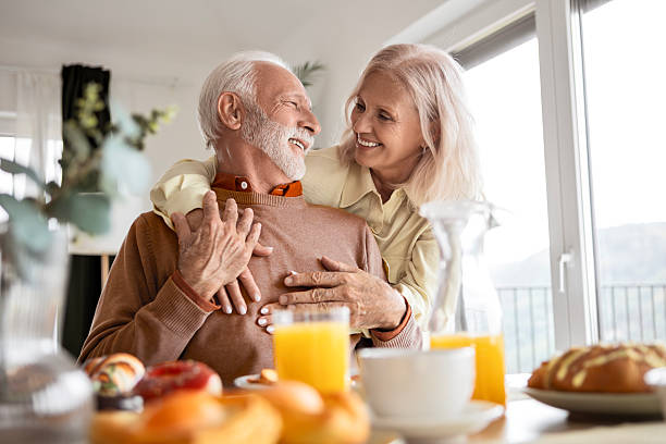 istock Retired Couple Relaxing with Coffee and Breakfast 2241224639