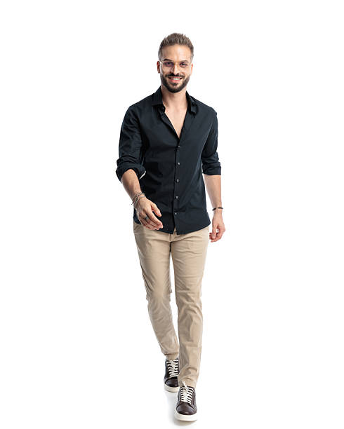 istock happy casual man with glasses looking forward and walking 2241228642