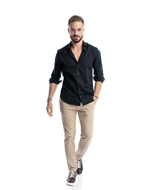 istock cool casual man with glasses walking with hand in pocket and looking forward 2241228662