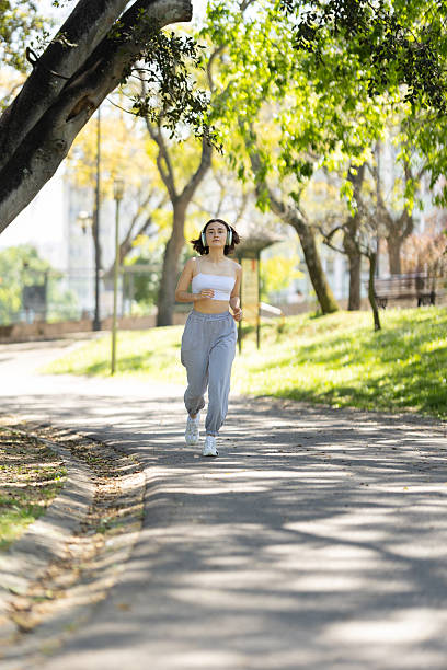 istock A woman is running on a path in a park 2241228823