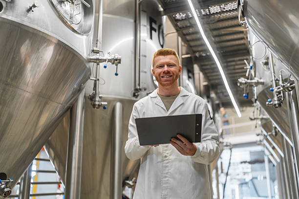 istock Man in lab coat working in beer production brewery 2241228937