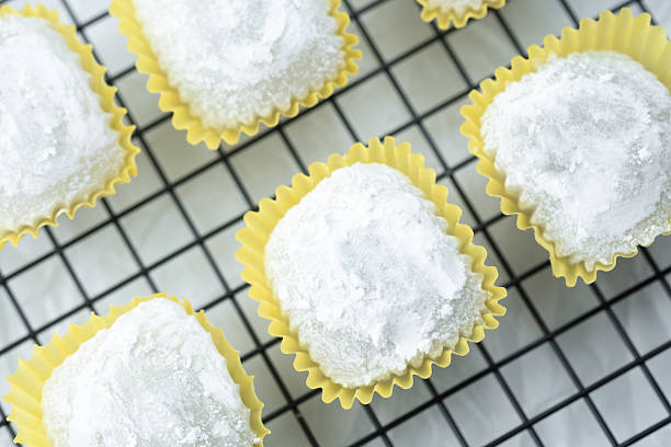 istock Delicate rice cakes dusted with powder cooling on a wire rack 2241230574