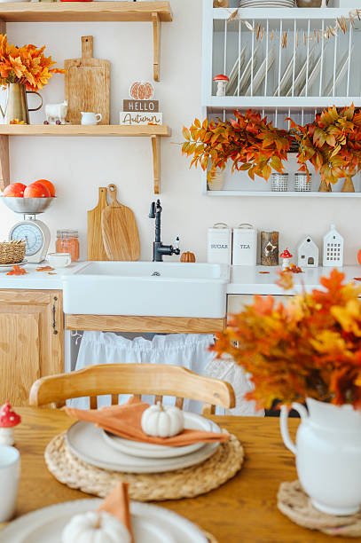 istock Autumn kitchen decor with maple leaves and pumpkins, farmhouse style 2241230774
