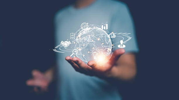 istock Man holding glowing digital globe with business icons, symbolizing global connection, innovation, technology, data network and modern digital communication concepts. 2241231497