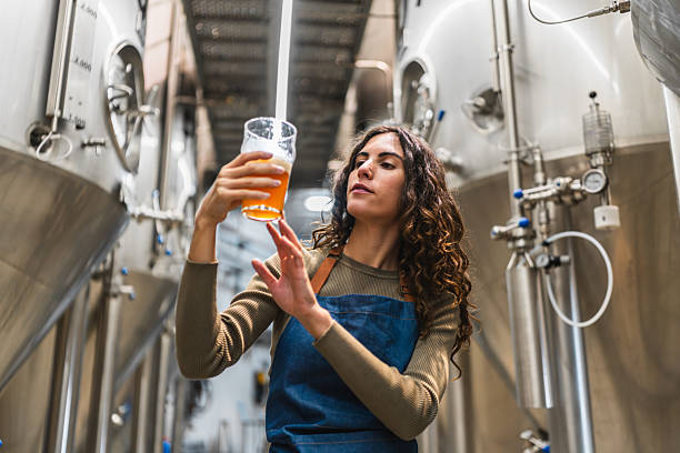 istock Woman brewer inspecting craft beer for quality control 2241231583