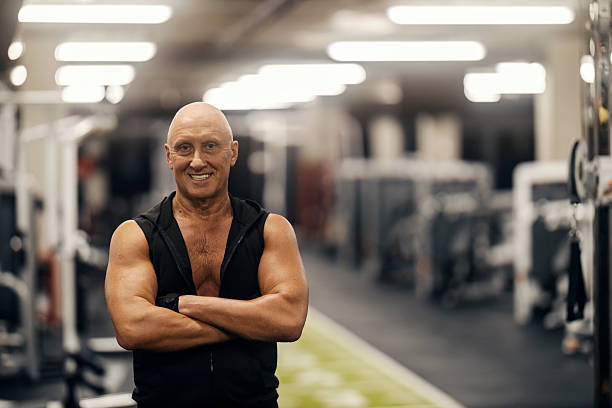 istock Senior man smiling standing in gym 2241235167
