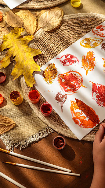 istock Autumn leaf art project with paint and brushes 2241239402